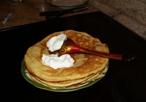 Pancakes, whipped cream and a spoon